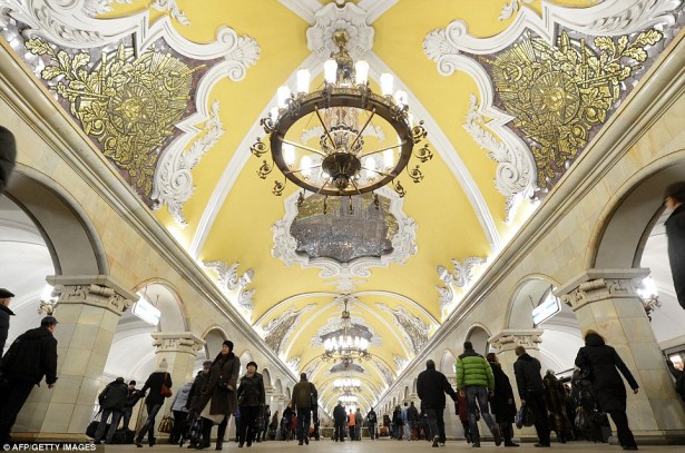 Moscow’s Komsomolskaya metro station covered in Baroque-style ornaments and chandeliers.