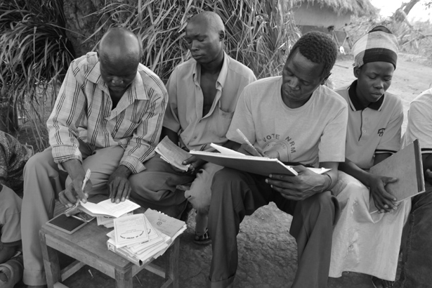 VSLA members keep track of their finances using passbooks printed in Gulu.
