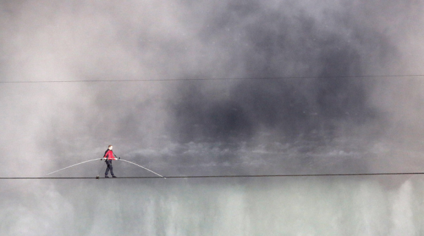 Aerialist Nik Wallenda walks the tightrope over Niagara Falls in Canada. Wallenda walked across the 1,800-feet-long, 2-inch-wide wire as the first person to cross directly over the falls from the United States into Canada.