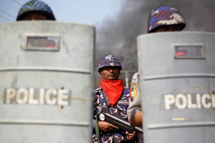 Policemen provide security amid riots in Meikhtila.