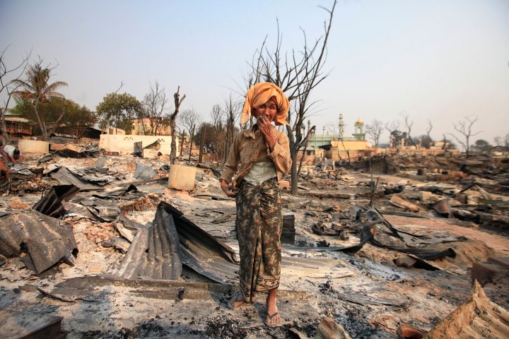 A Buddhist woman outside her home that was burned down during the riot.