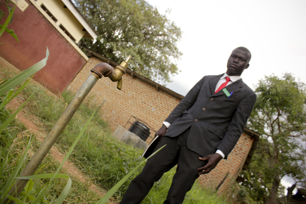 David, the Head Prefect at Sir Samuel Baker school, inspects one of the water sources for damage.