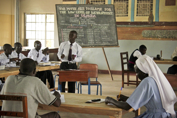 A student from Layibi Secondary School makes his case in an early debate round against Awere Secondary School