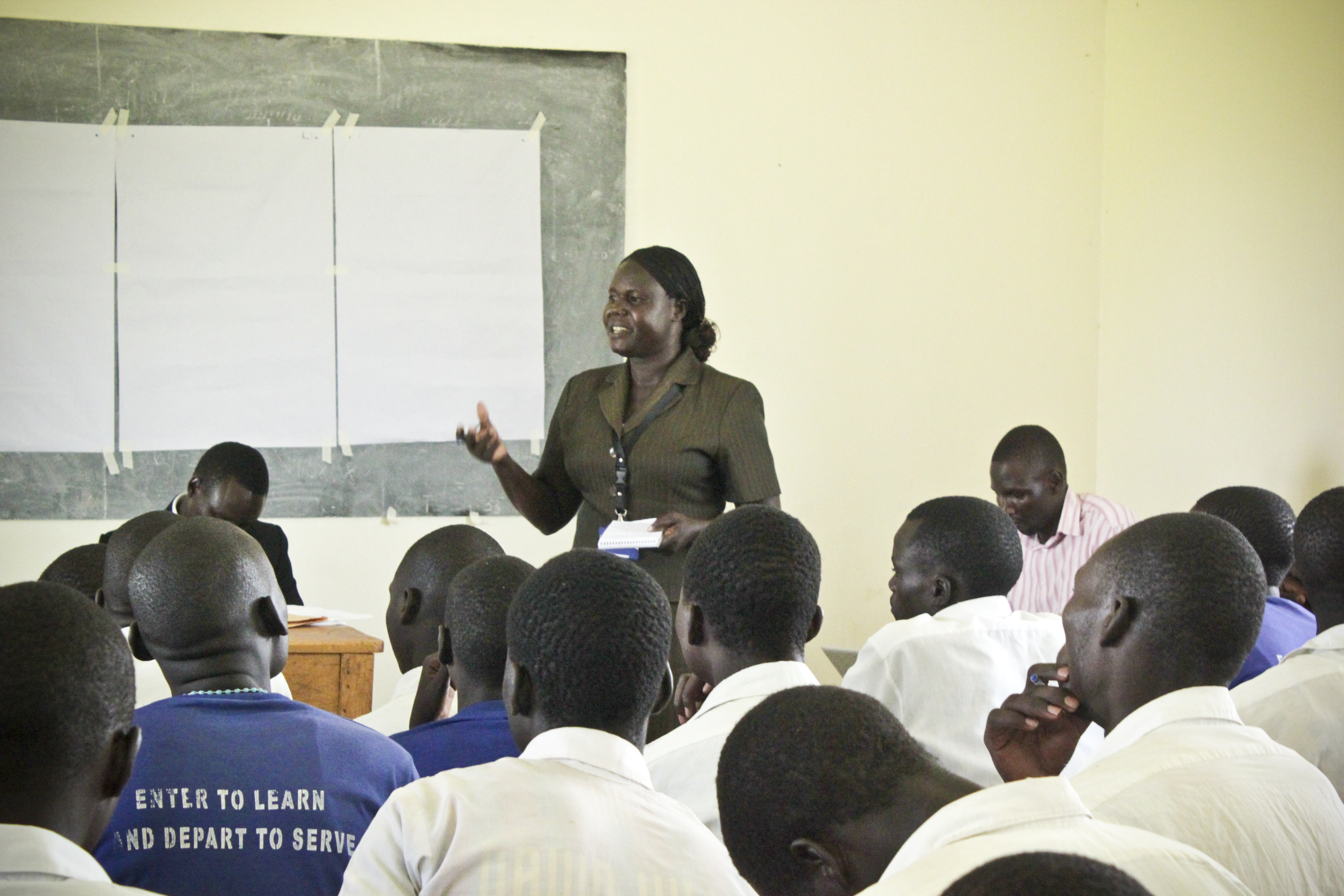 Invisible Children mentor Betty talks to the students of Pabbo Secondary School during a career guidance session