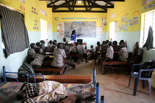 Collines' sister, Rita, teaches the children a song of hope.