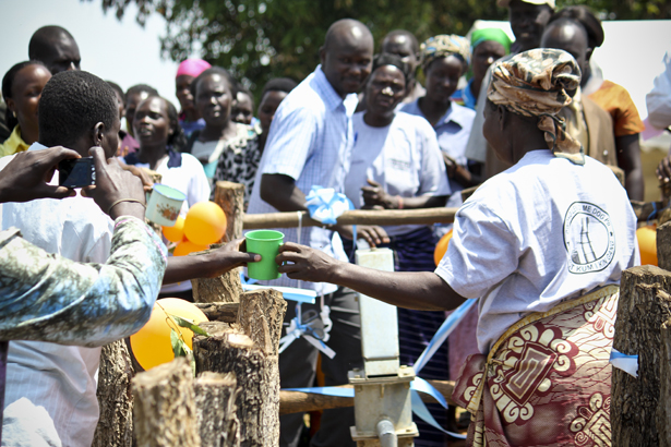 The first cup of water served from the new borehole.