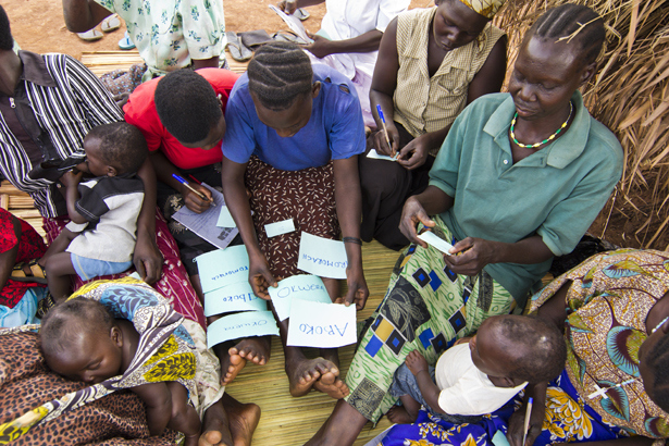 Community members practice their reading and writing. Since many groups have completed the first course of Functional Adult Literacy classes in their local language, many have been asking to continue the training – but this time with English.