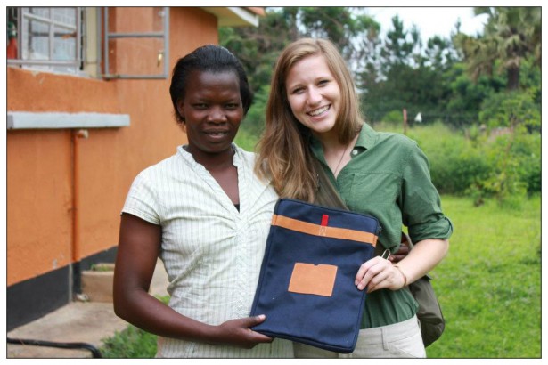 Carolyn (right) showing off her Mend laptop case, handmade by seamstress Ajok Betty