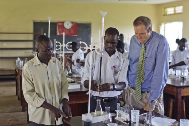 John, a TEX veteran, works alongside students in a chemistry lab. A math whiz, John has helped prepare students for their national exams alongside his Ugandan partner teachers.