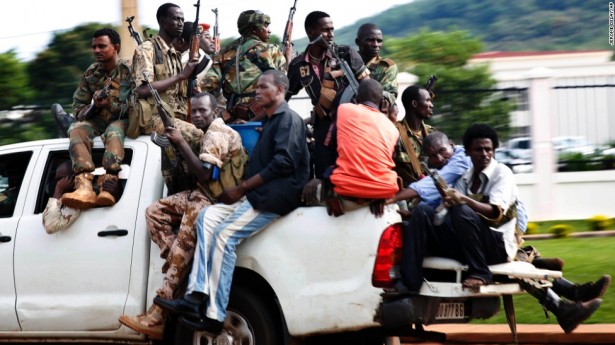 Seleka soldiers race through Bangui as gunfire and mortar rounds erupt in the capital December 5. (photo via CNN)