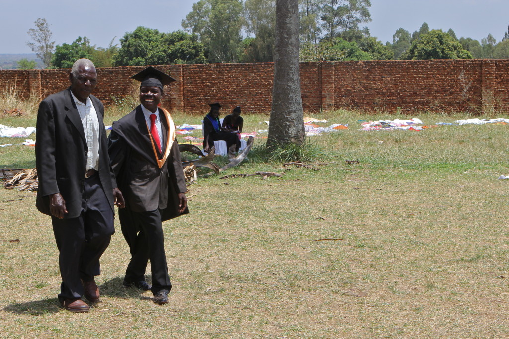 Okuli Wilfred (right) and his father at the Legacy Scholarship Program graduation celebration.