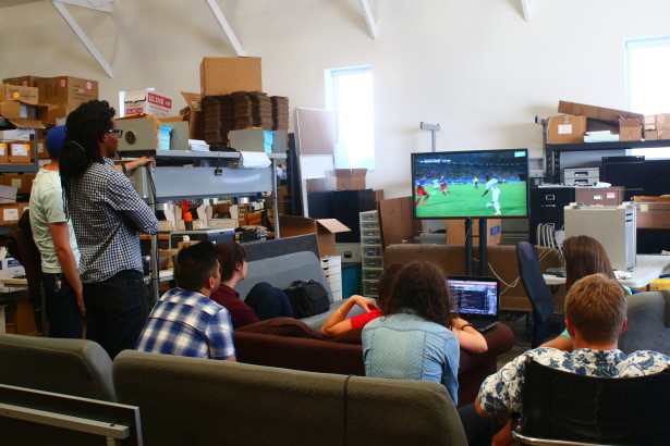 Some of our interns and staff crowded around the TV in our warehouse, watching a World Cup match. 