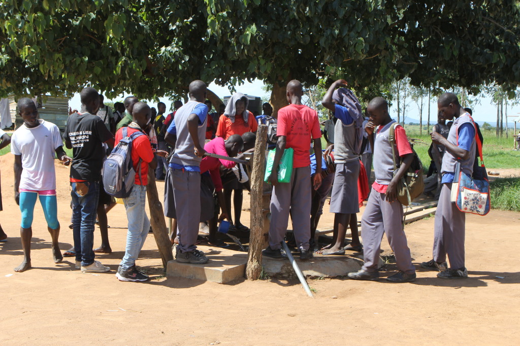 Following athletic activities, the borehole at Pabo Secondary School is a favorite spot for students. It was drilled by the Schools for Schools Program.
