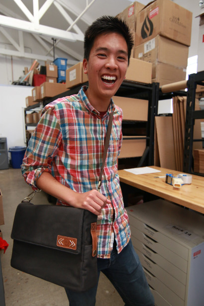 Adam, our Video Production intern, showing off the grey messenger bag.